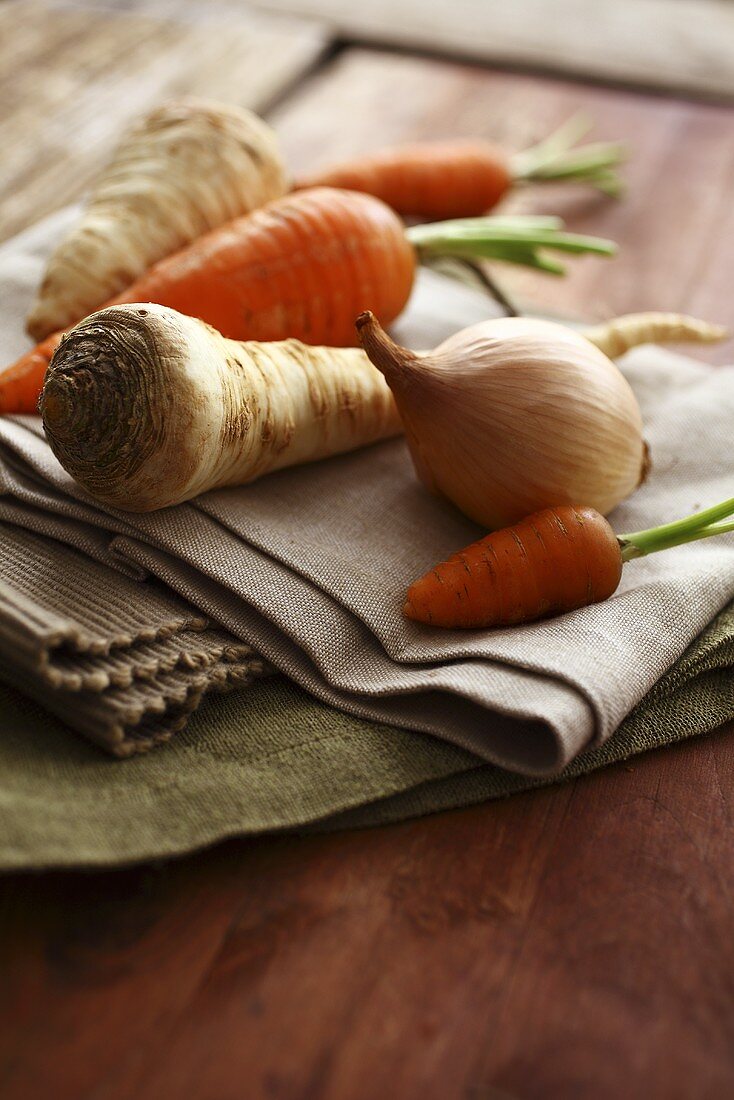 An onion, carrots and a parsnip