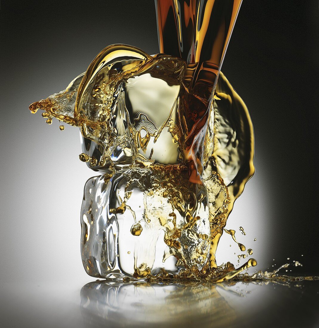 Cola being poured over ice cubes