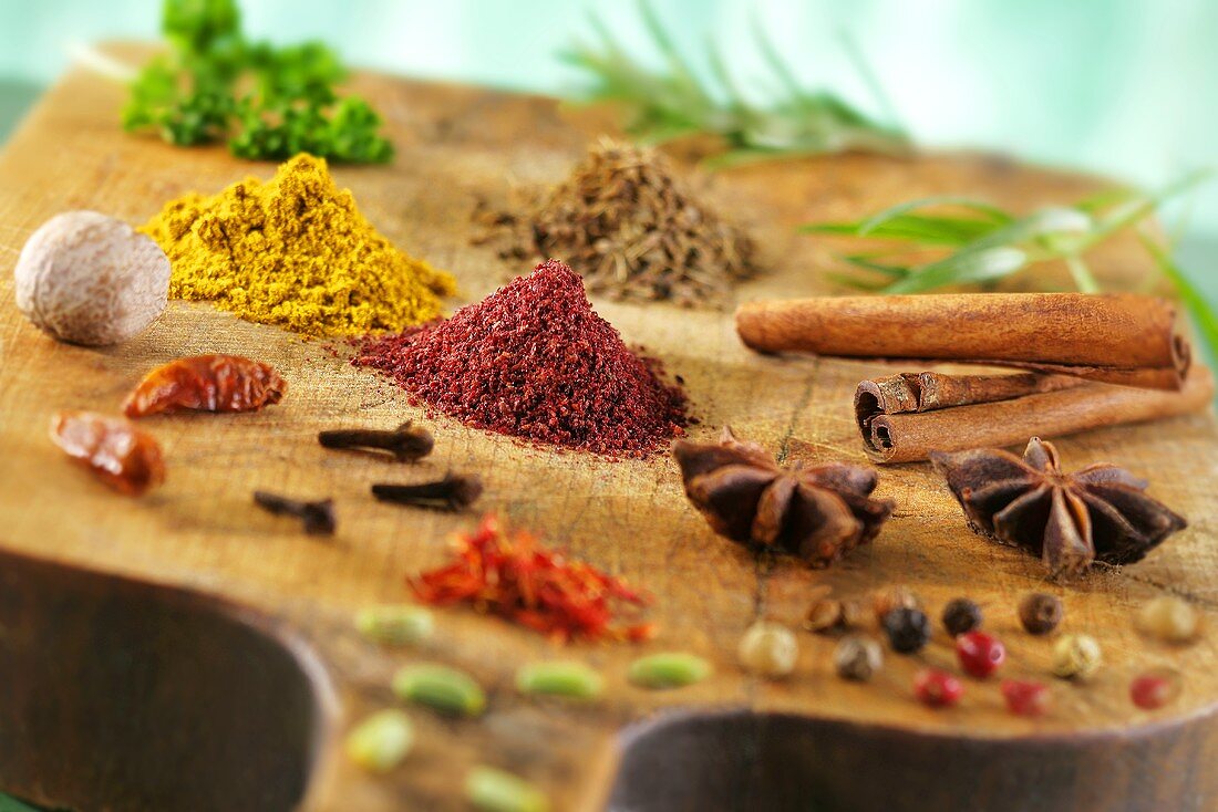 Various spices on a wooden board