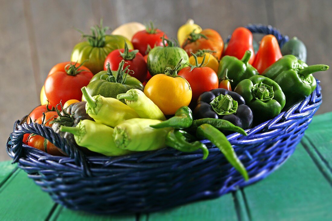 A basket filled with tomatoes and peppers