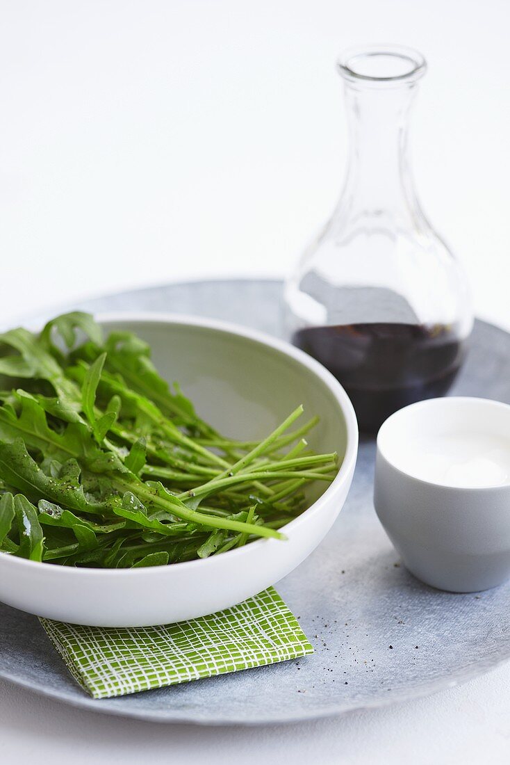 Rocket in a bowl with salad dressing