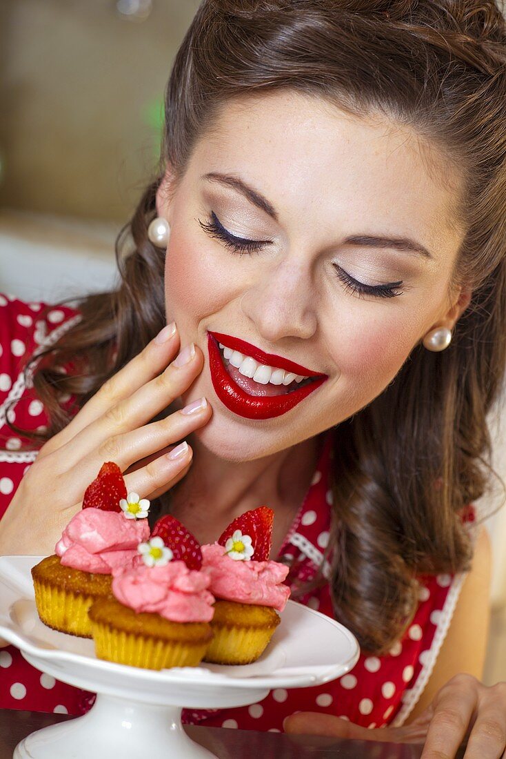 A retro-style girl with strawberry muffins