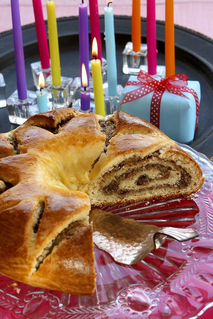 A nut roll, a present and colourful candles