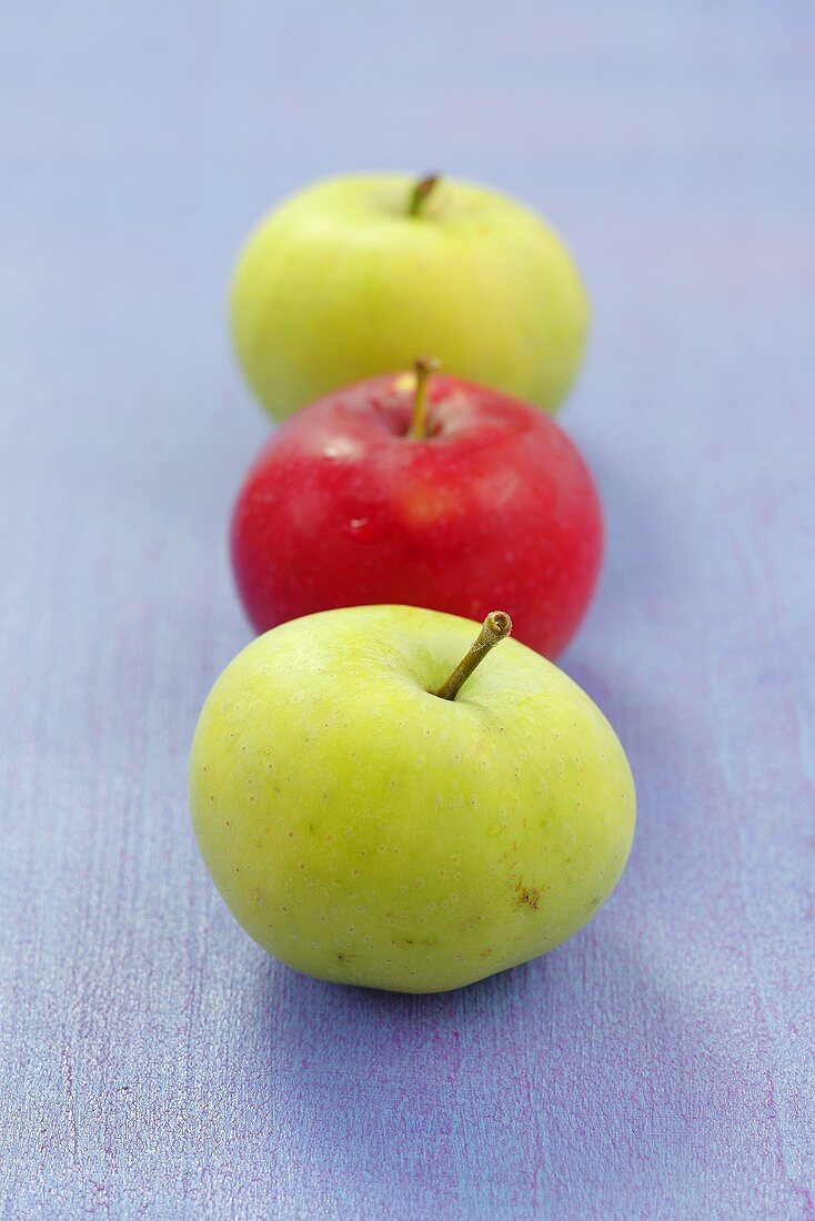 Three apples (two green, one red)