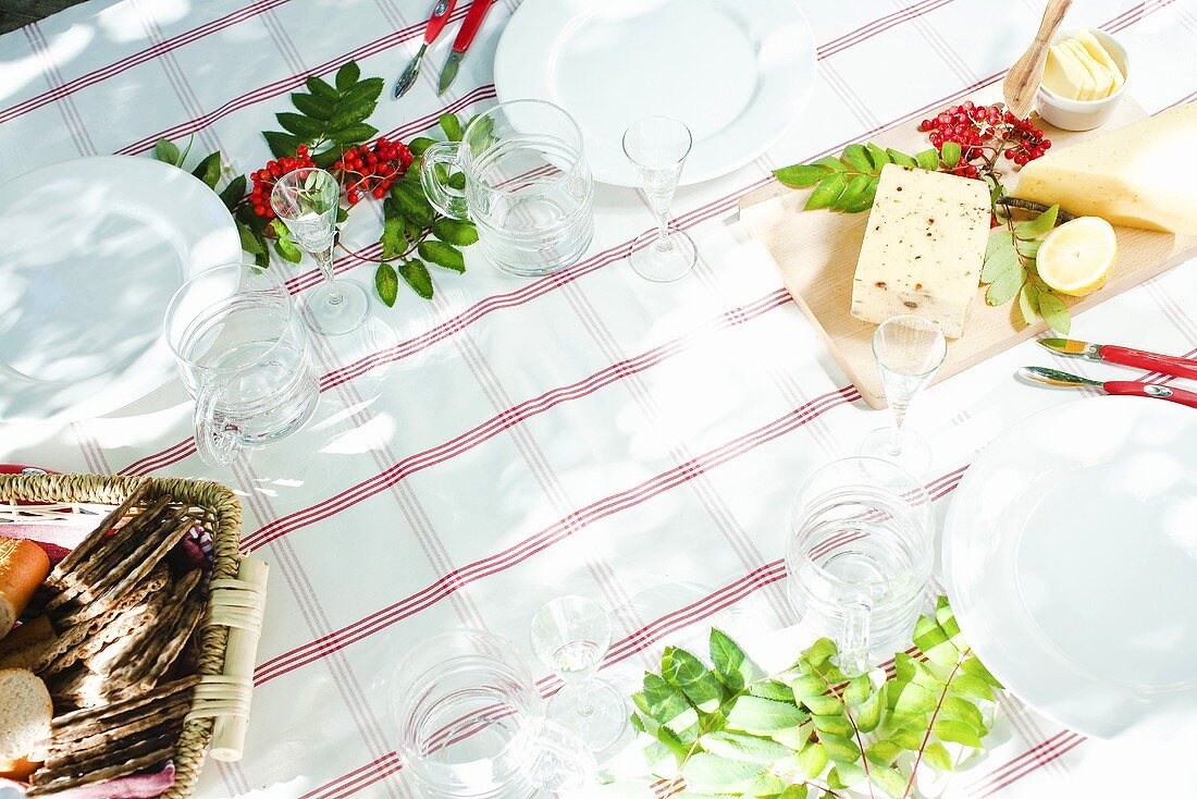 A table laid with glasses, crisp breads and butter