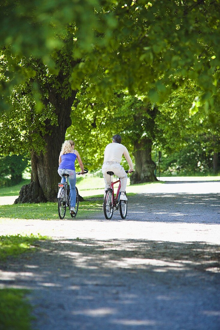 A couple cycling in a park