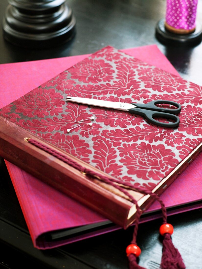 A photo album, scissors and a note book