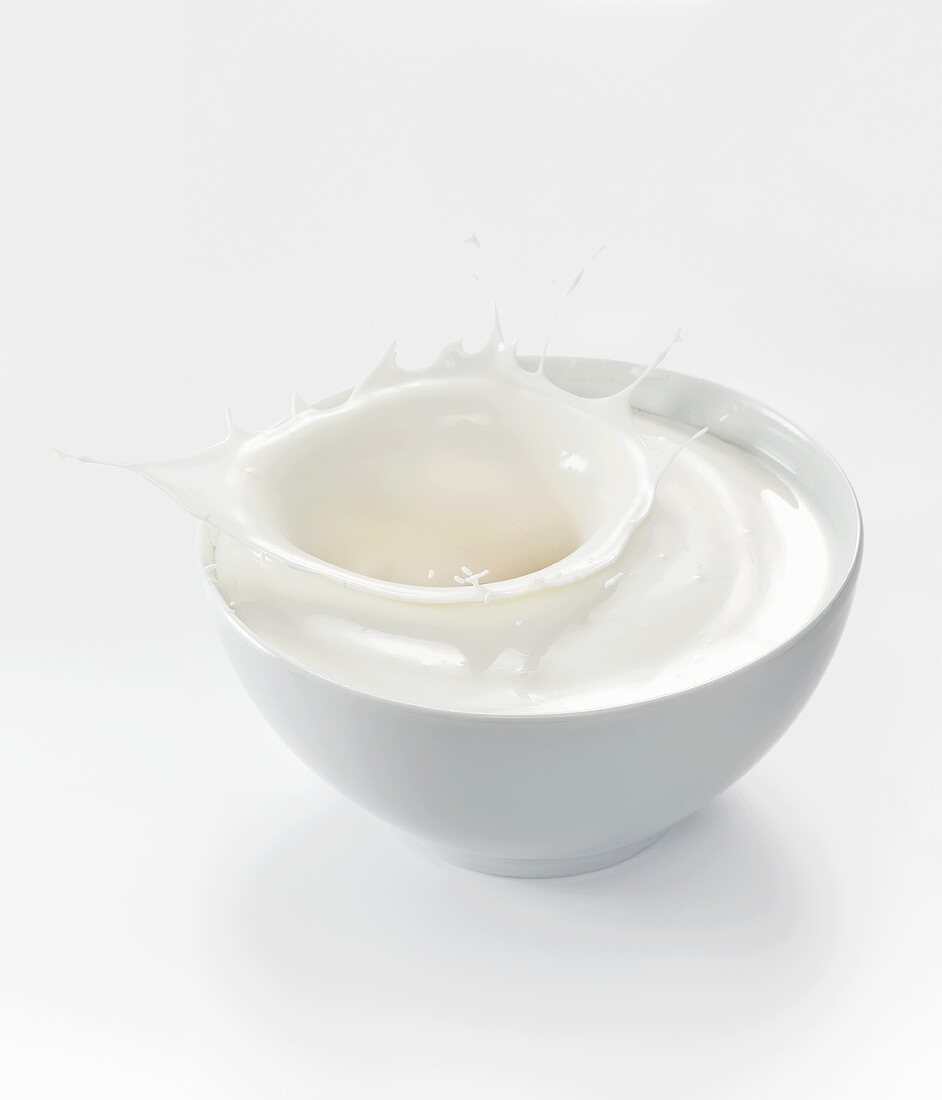 A splash of yogurt in a white bowl