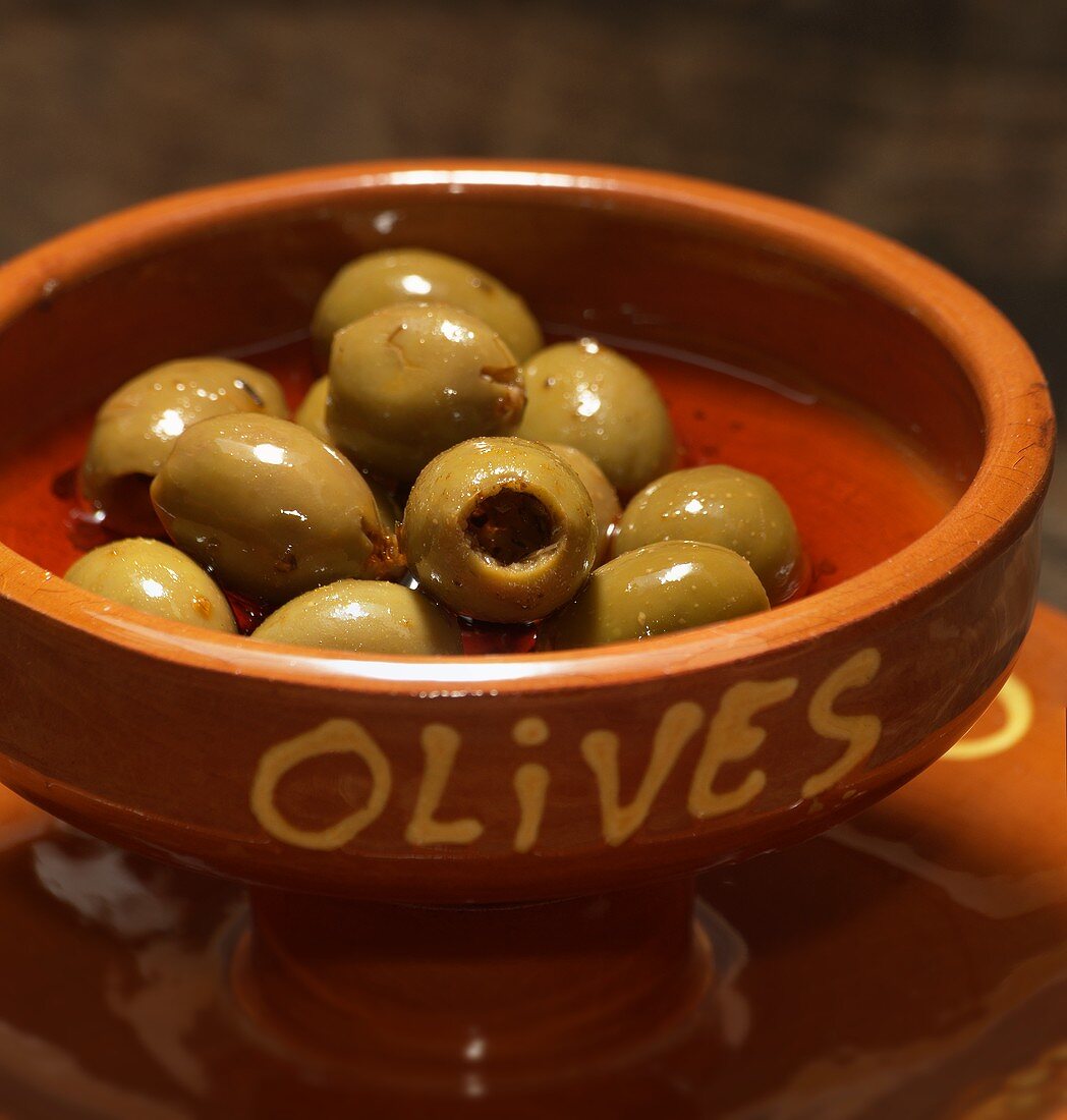 Green olives in a terracotta bowl