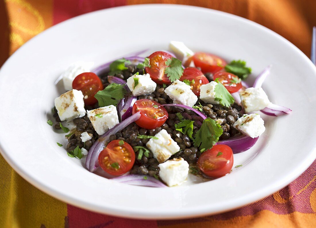 Lentil salad with sheep's cheese, tomatoes and onions