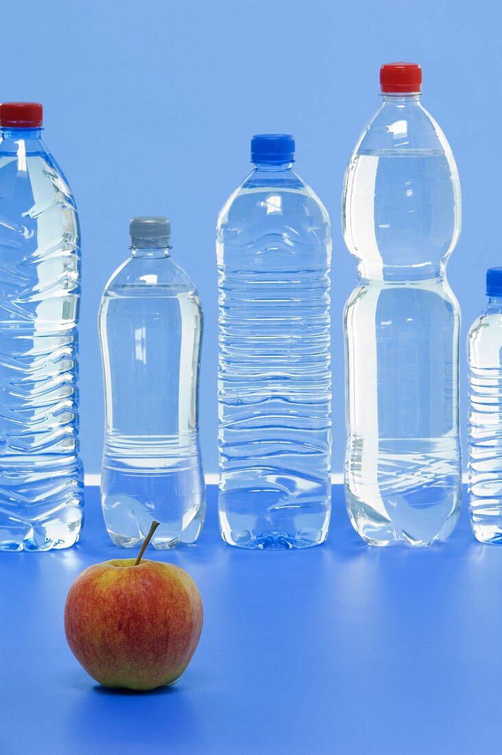 An Elstar apple and various bottles of mineral water