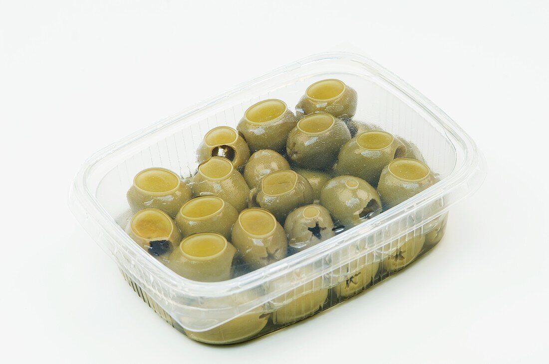 Green olives in a plastic container