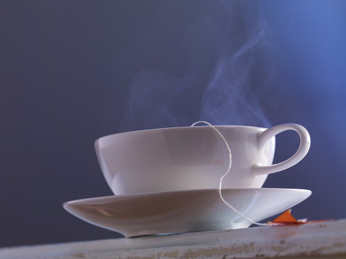 A streaming cup of tea with a tea bag