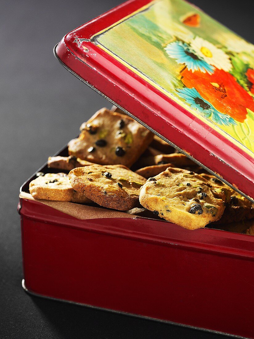 A biscuit tin filled with chocolate chip cookies