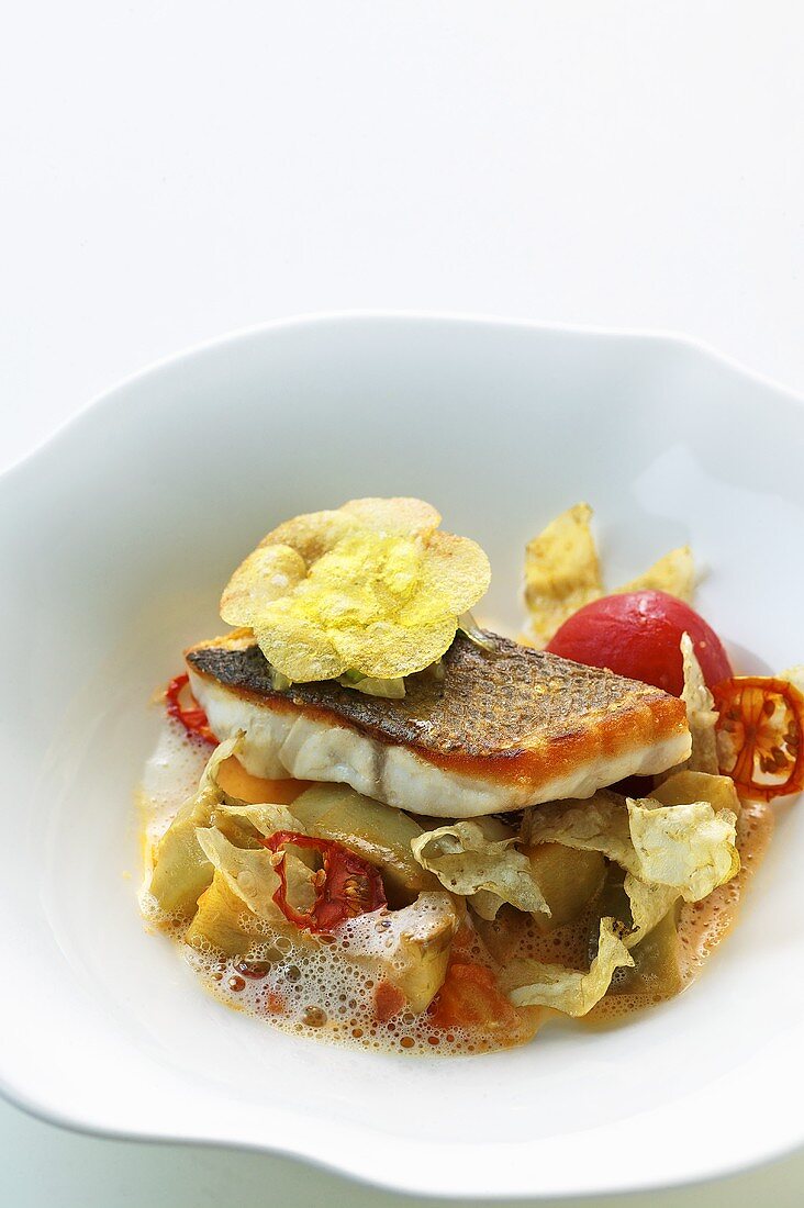 Bass with artichokes, tomatoes and braised onions