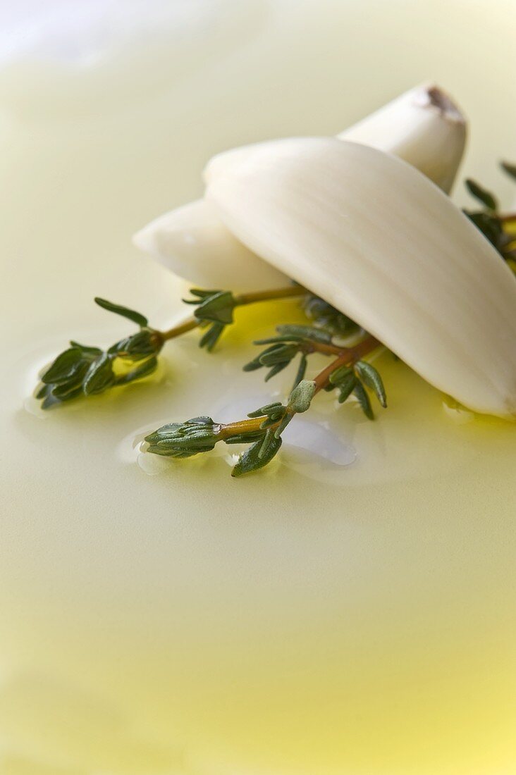 Two Garlic Cloves with Two Thyme Sprigs in Olive Oil