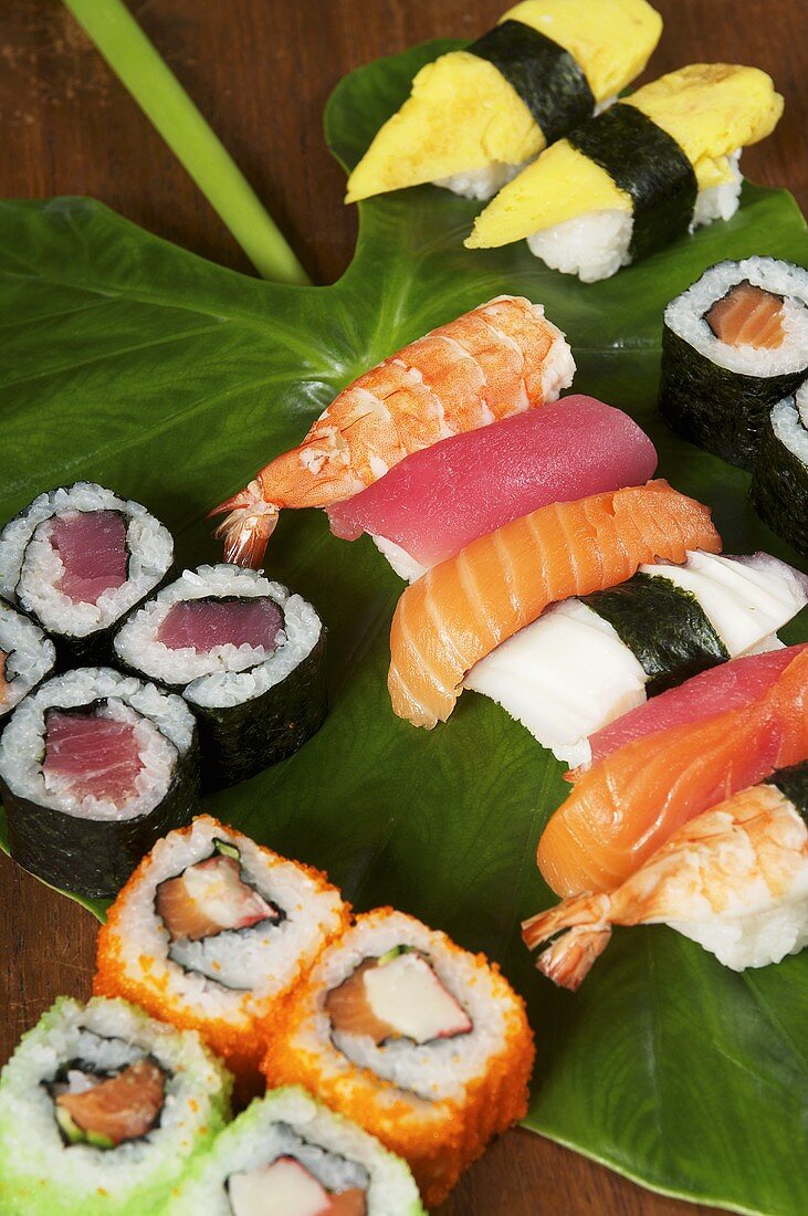 Various types of sushi on a leaf