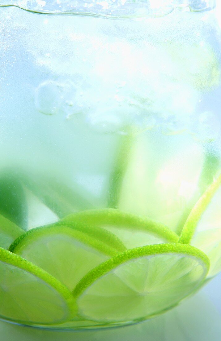 A jug of water with limes (close-up)