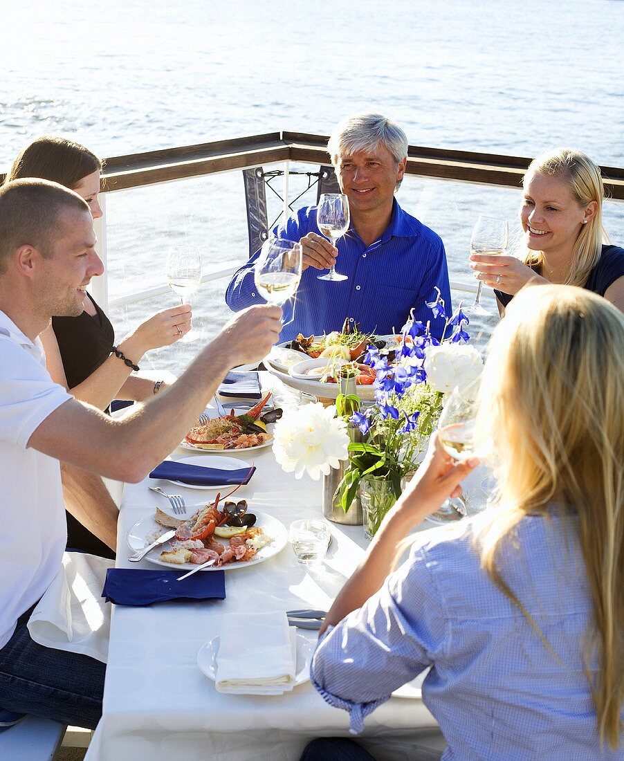 Group celebrating at a restaurant by the water