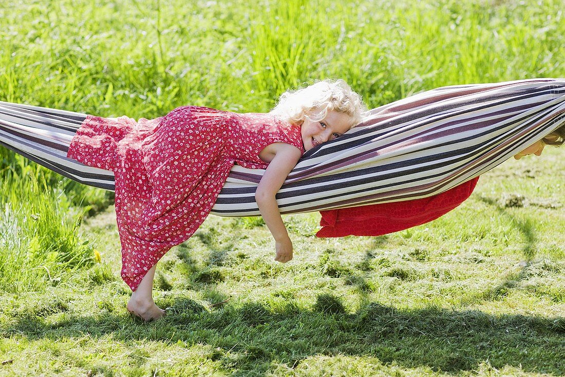 Two little girls playing with a hammock