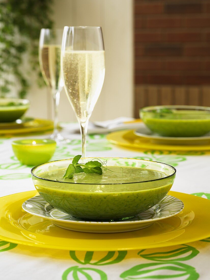 Cream of pea soup with a glass of champagne