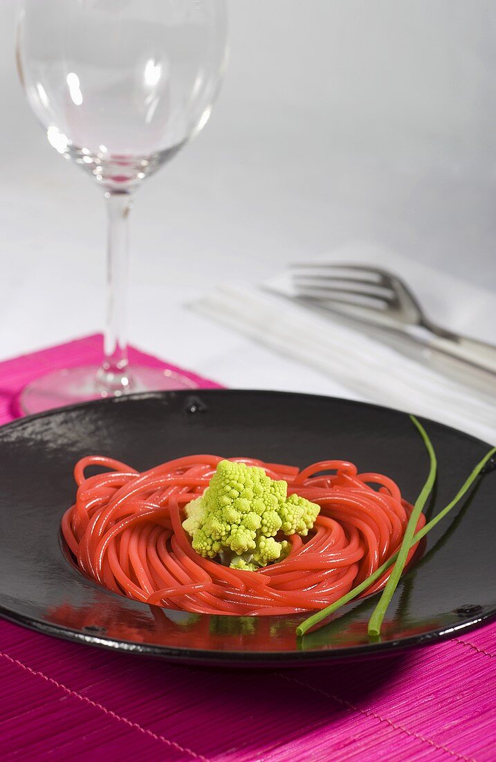 Pink colored spaghetti with Romanesco