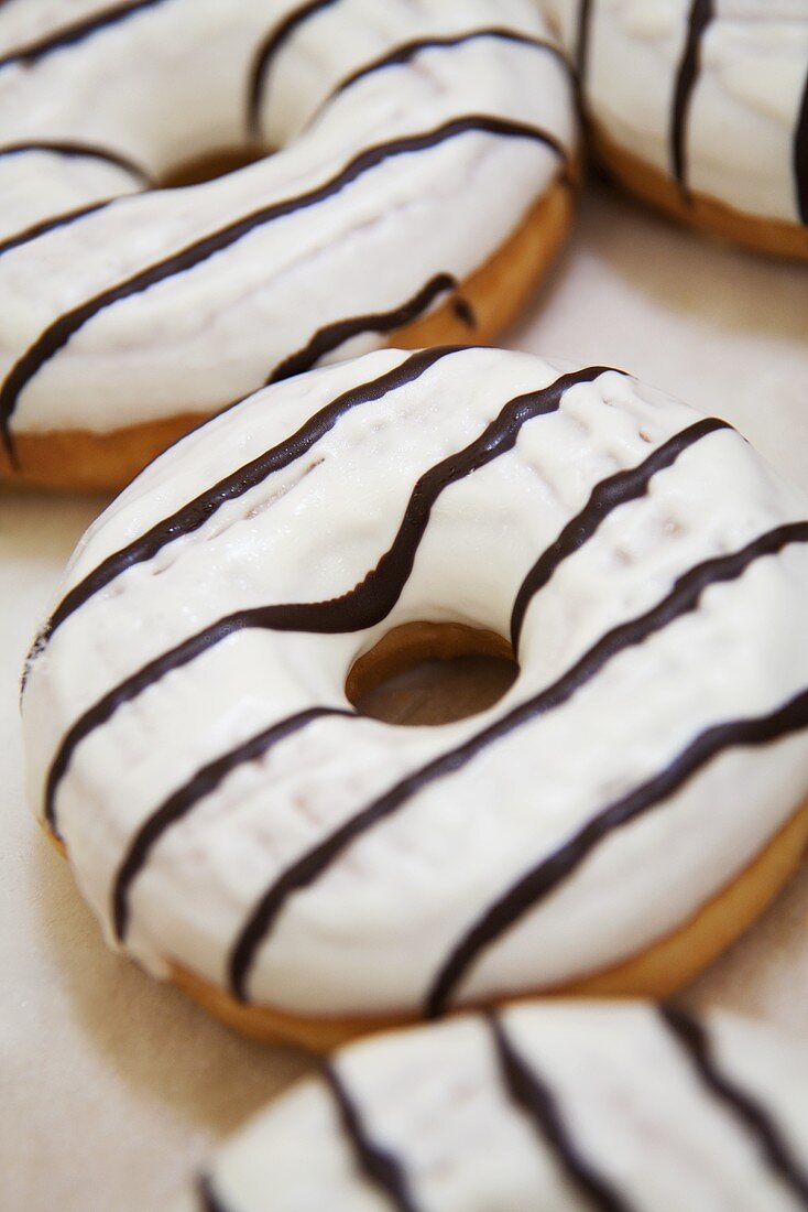 Iced donuts with chocolate stripes