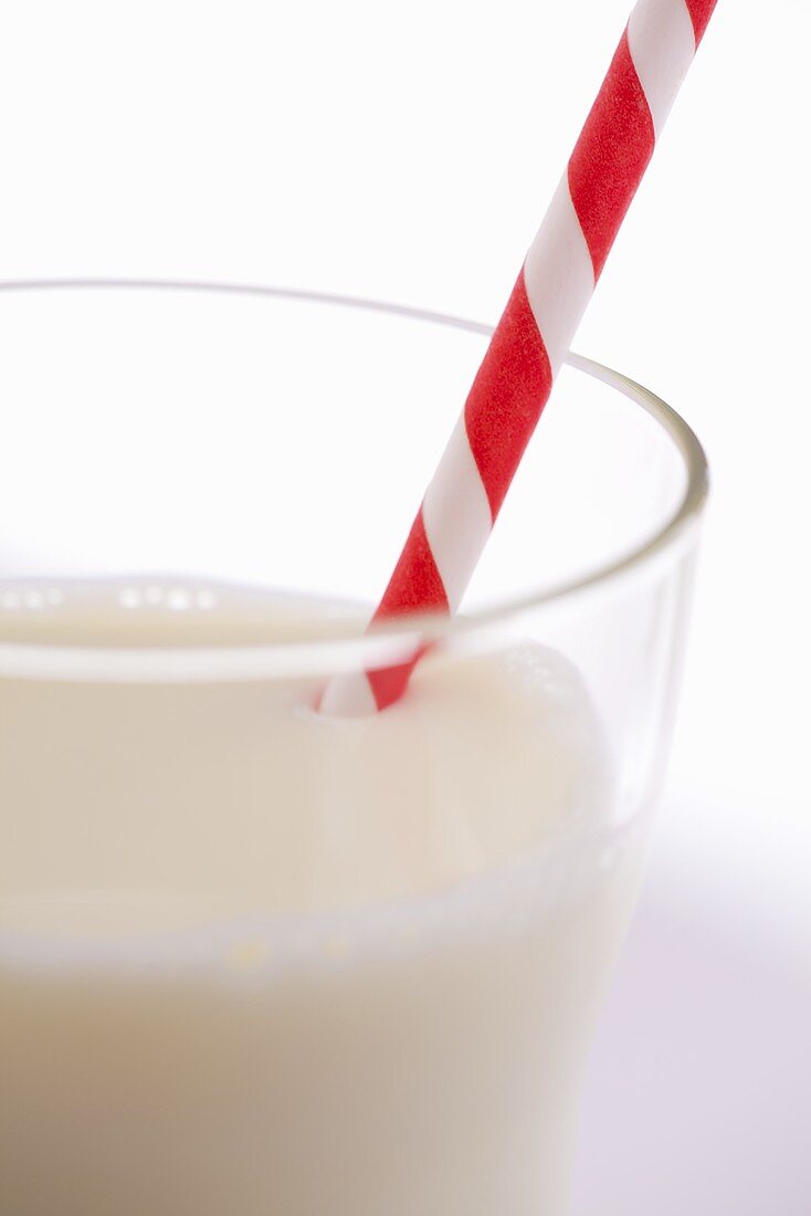 Glass of milk with a straw