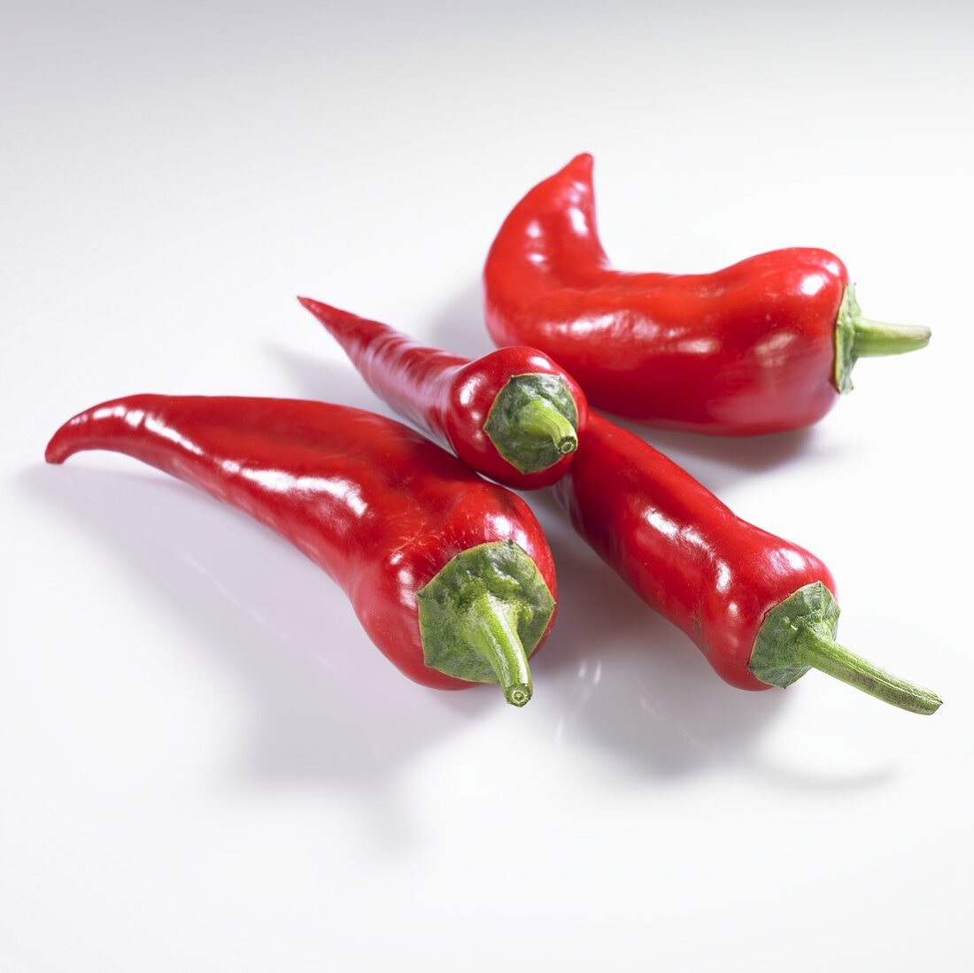 Four red pointed peppers