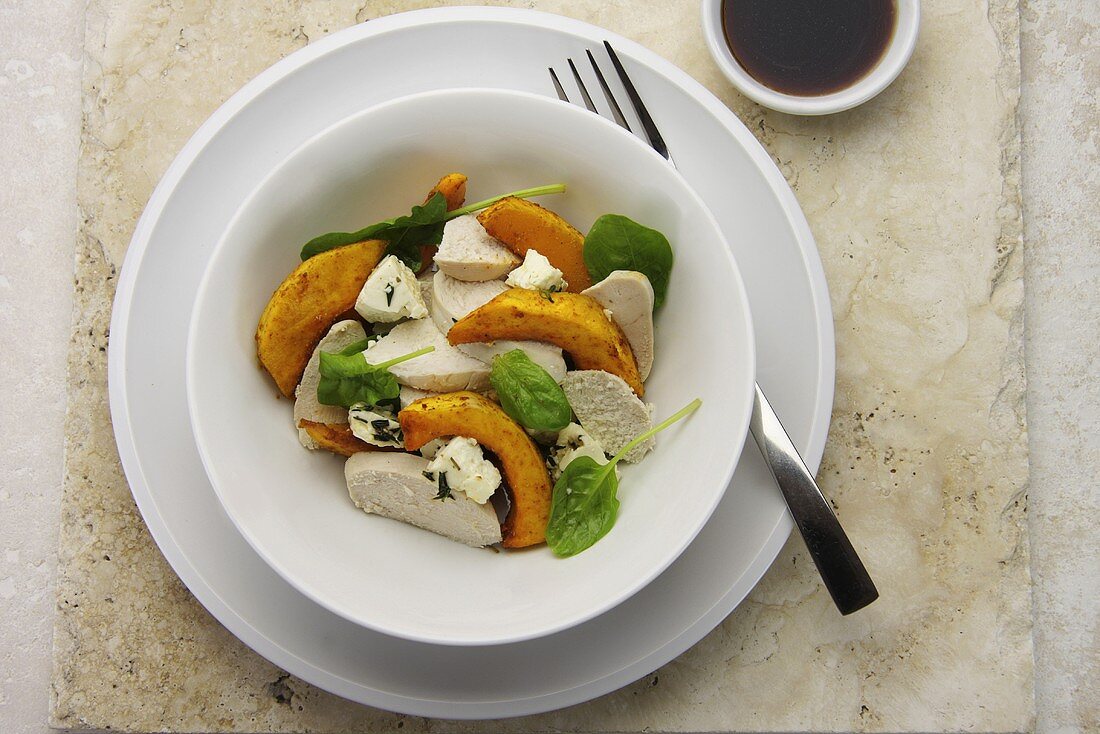 Fried butternut squash, poached chicken, spinach and feta salad