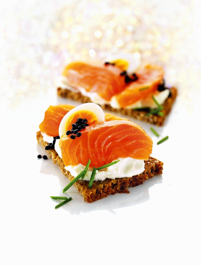 Whole-grain bread with cottage cheese, salmon, egg and caviar