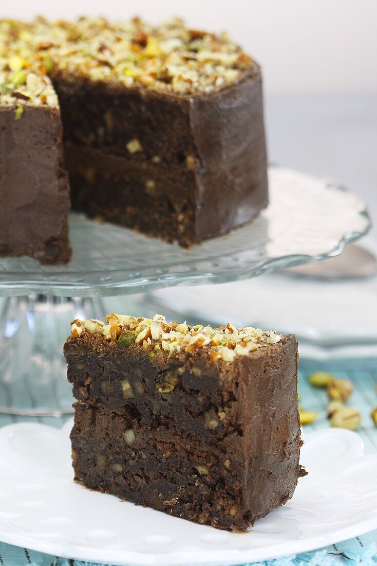 Chocolate brownie cake with nuts and pistachios, sliced