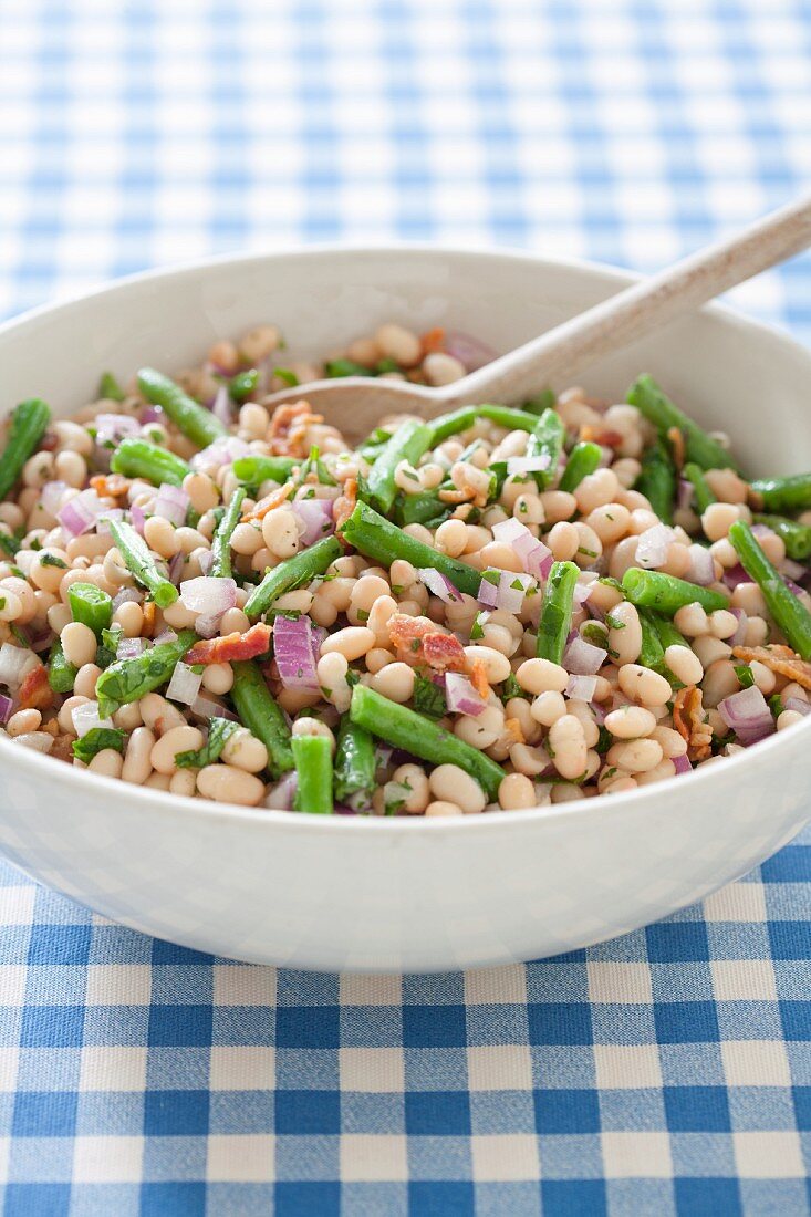 White Bean Salad with Green Beans and Onions; In Serving Bowl with Wooden Spoon