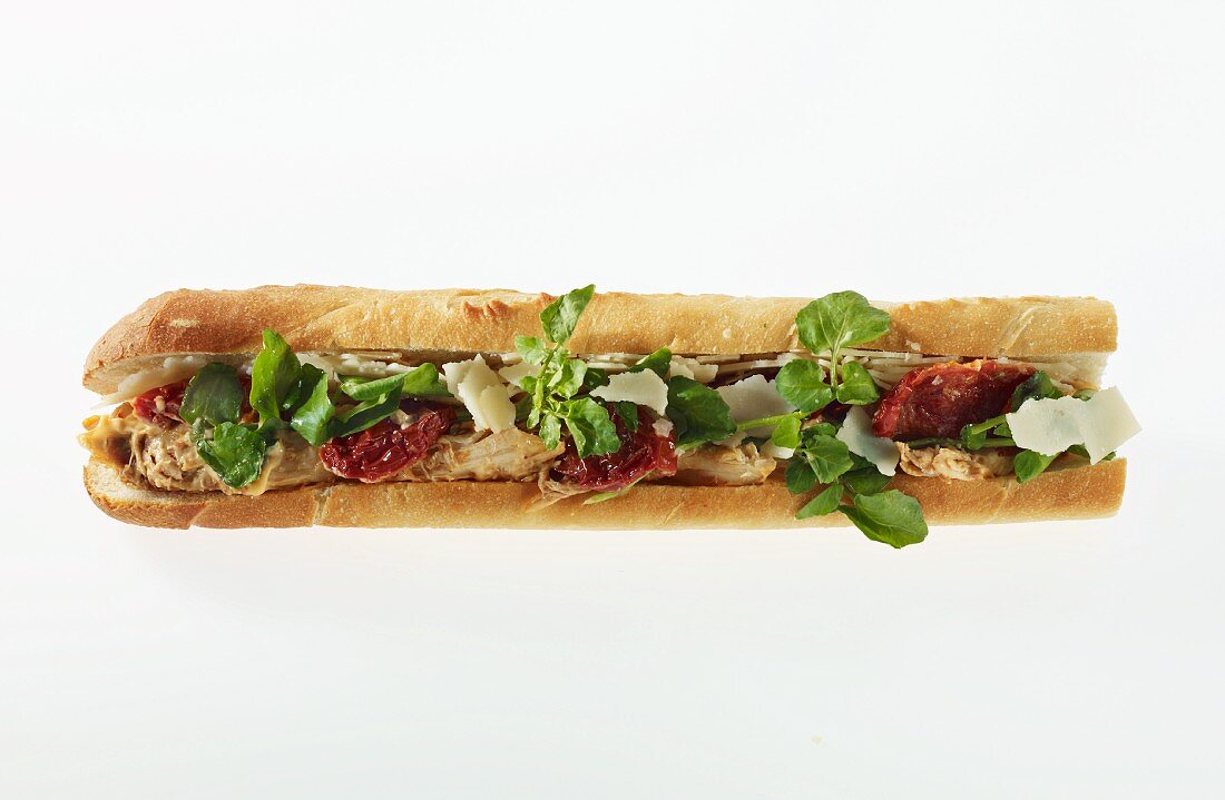 A chicken and dried tomato sandwich on a baguette