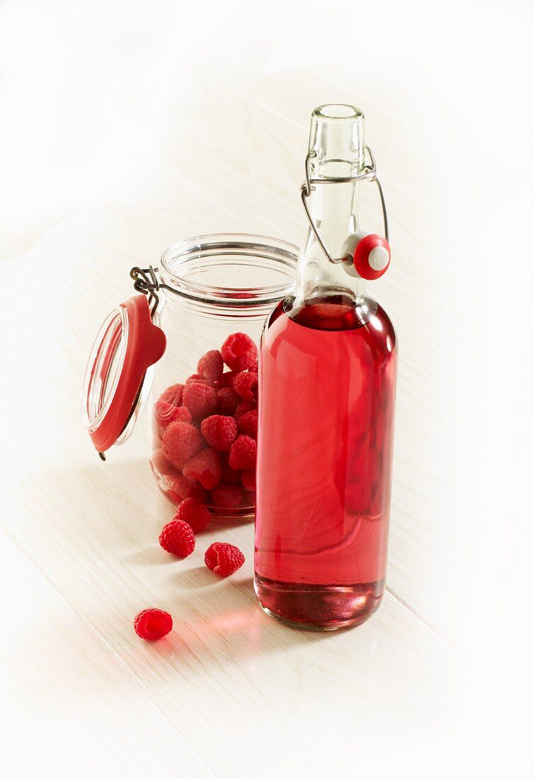 Fresh raspberries and a bottle of raspberry liqueur