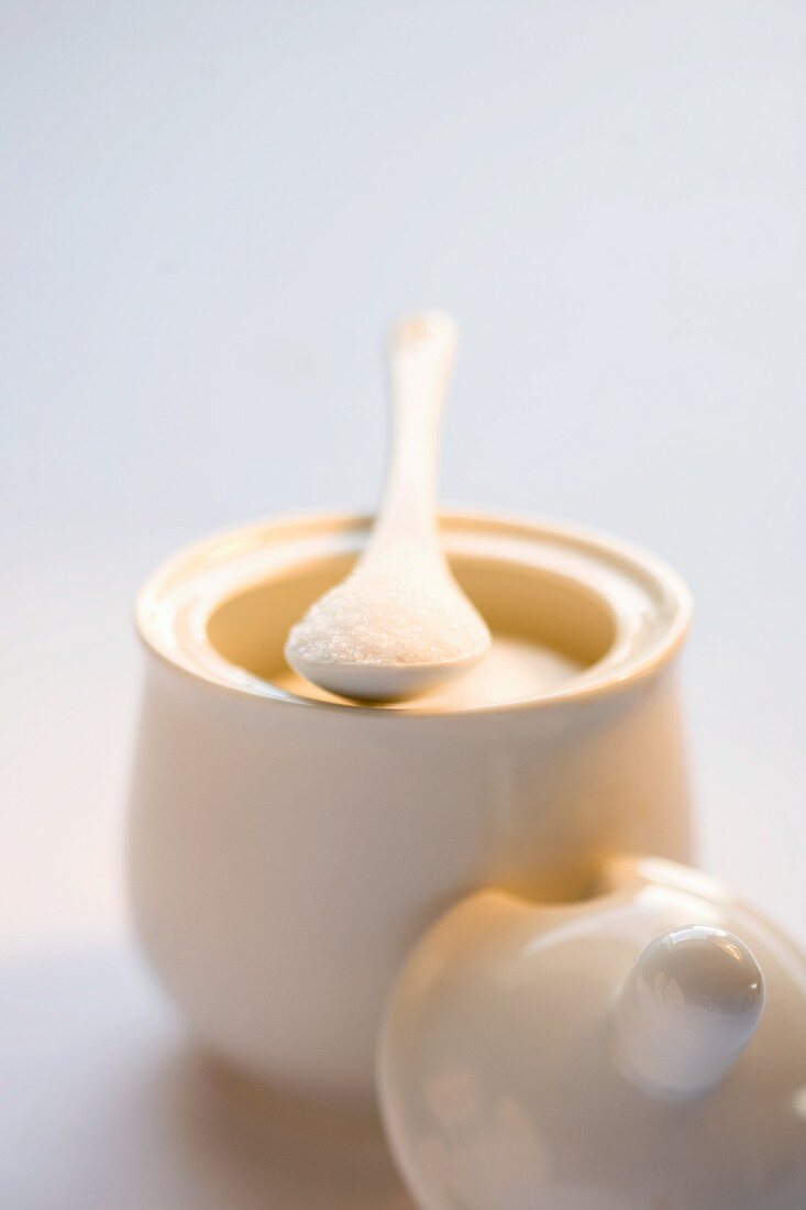 A sugar pot with a spoon