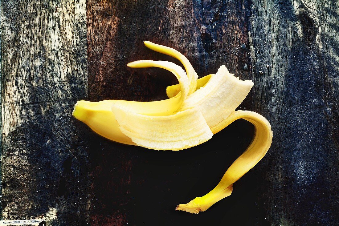 A half-peeled banana with a bit taken out