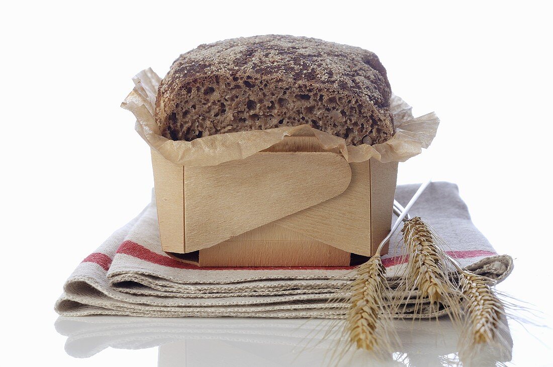 Wholegrain bread and cereal ears on tea towel