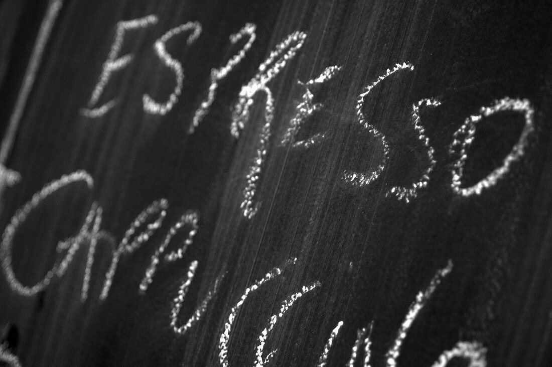 Blackboard with the words Espresso, Cappuccino written in chalk