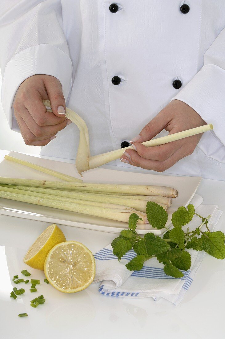 Female chef peeling lemon grass