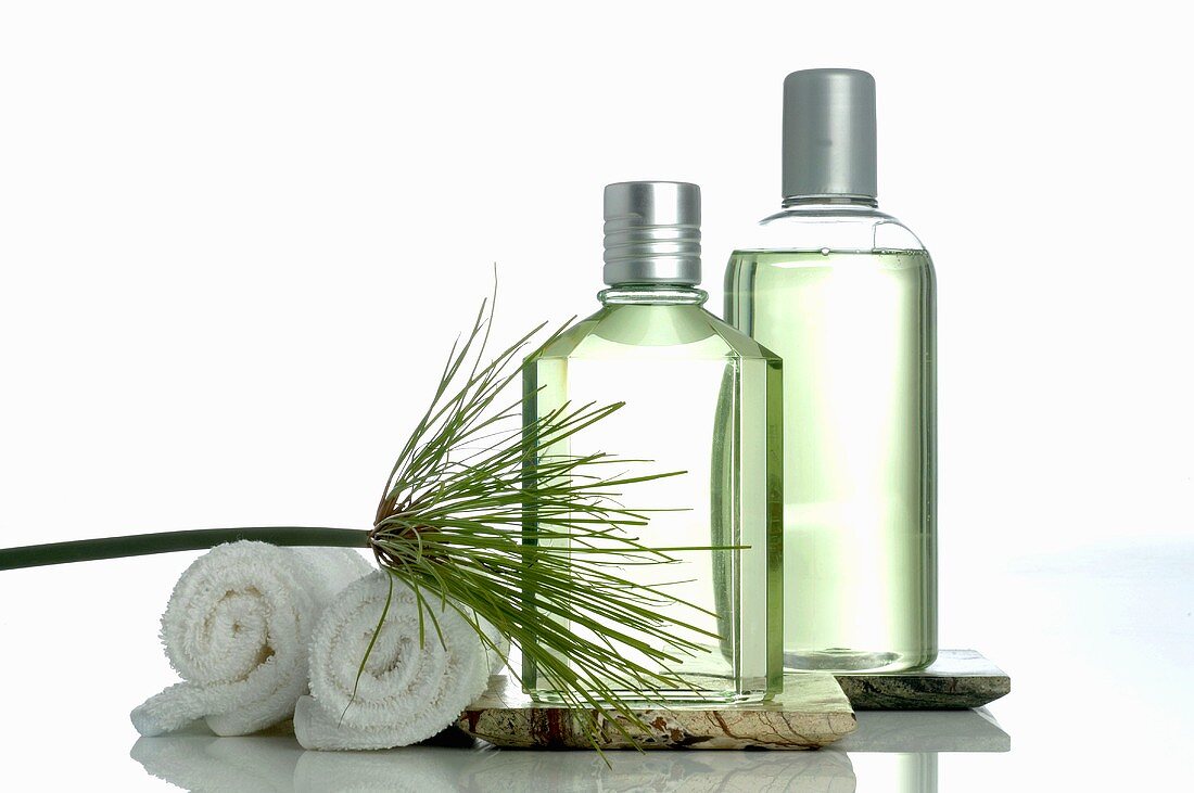 Two cosmetic bottles and towels