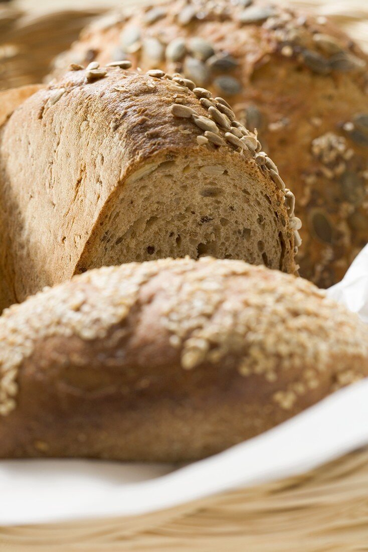 Three different loaves of bread in bread basket