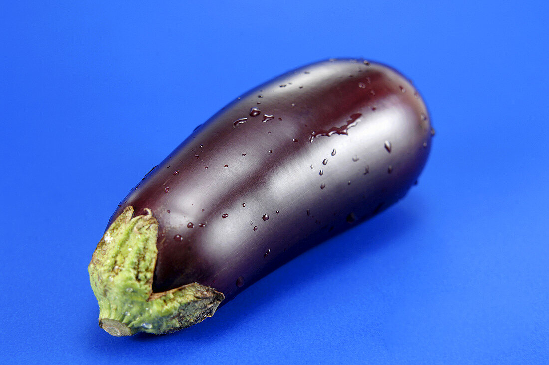Fresh aubergine with drops of water