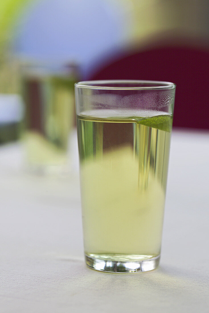 A glass of green tea with mint