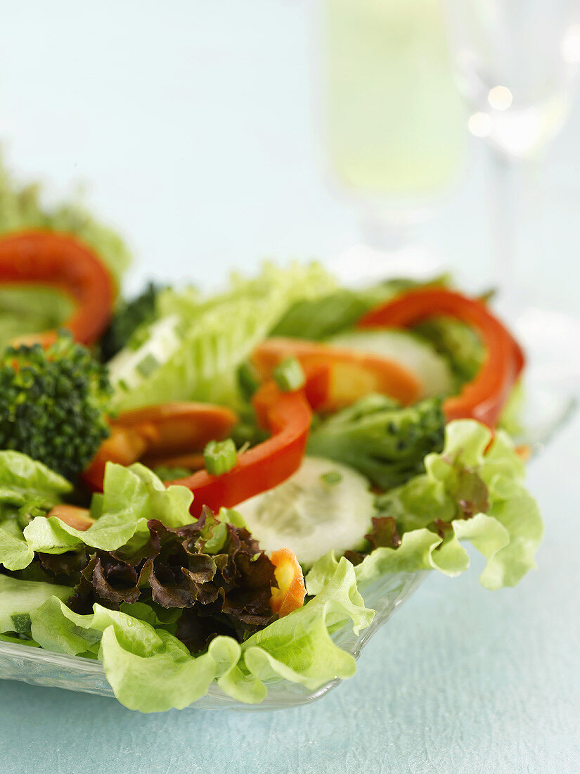 Mixed salad with lettuce and peppers on a glass platter