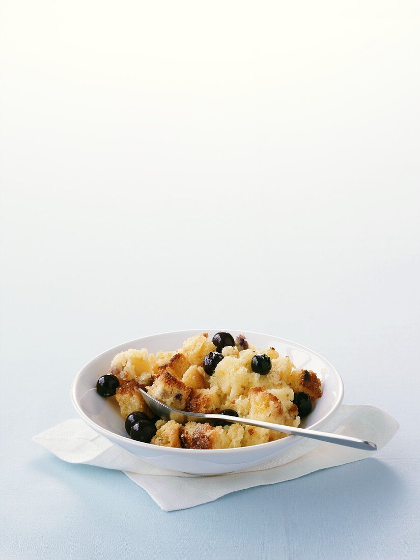 Bread and butter pudding with blueberries in a dish