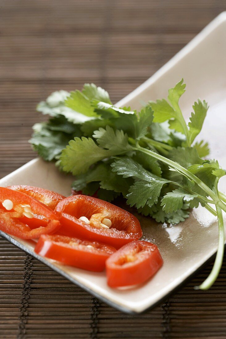 Sliced chilli and coriander leaves in a dish