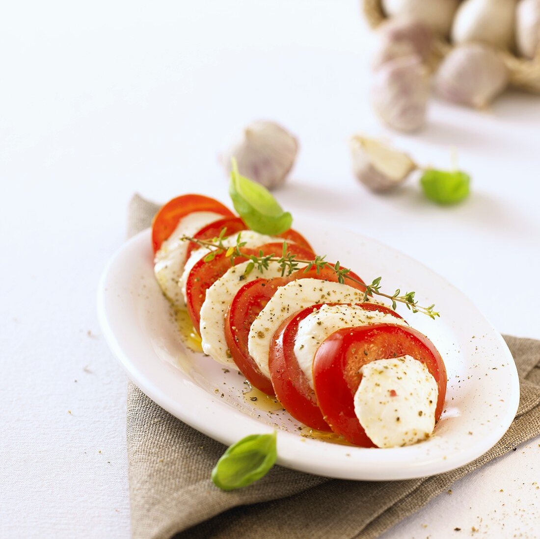 Tomato and mozzarella with herbs on a platter