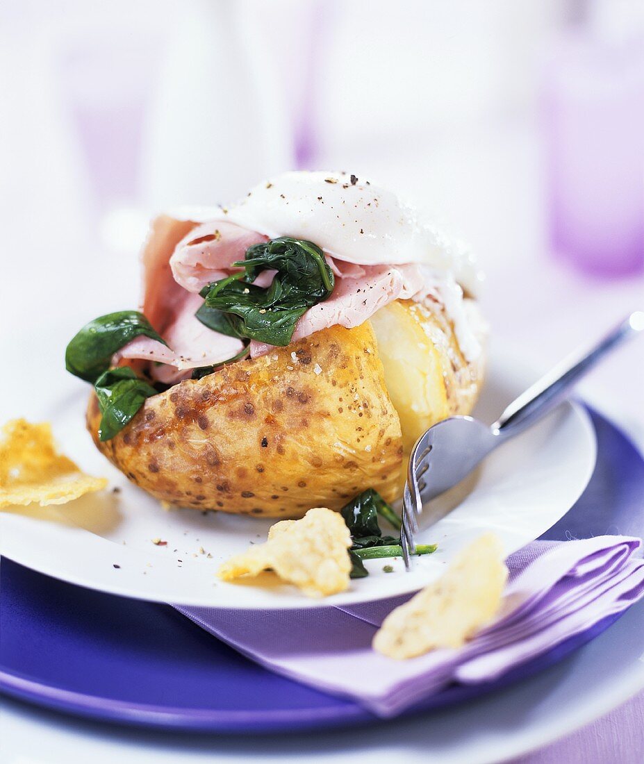 Baked potato with ham, spinach and poached egg