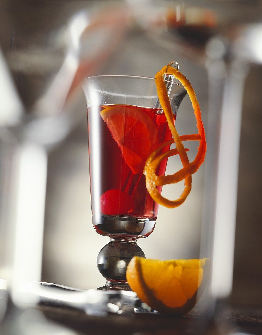 Campari cocktail with orange and cocktail cherry